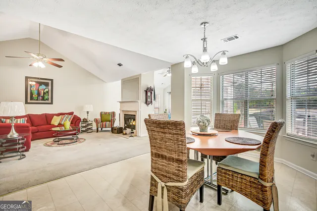 a dining room with furniture a chandelier and window