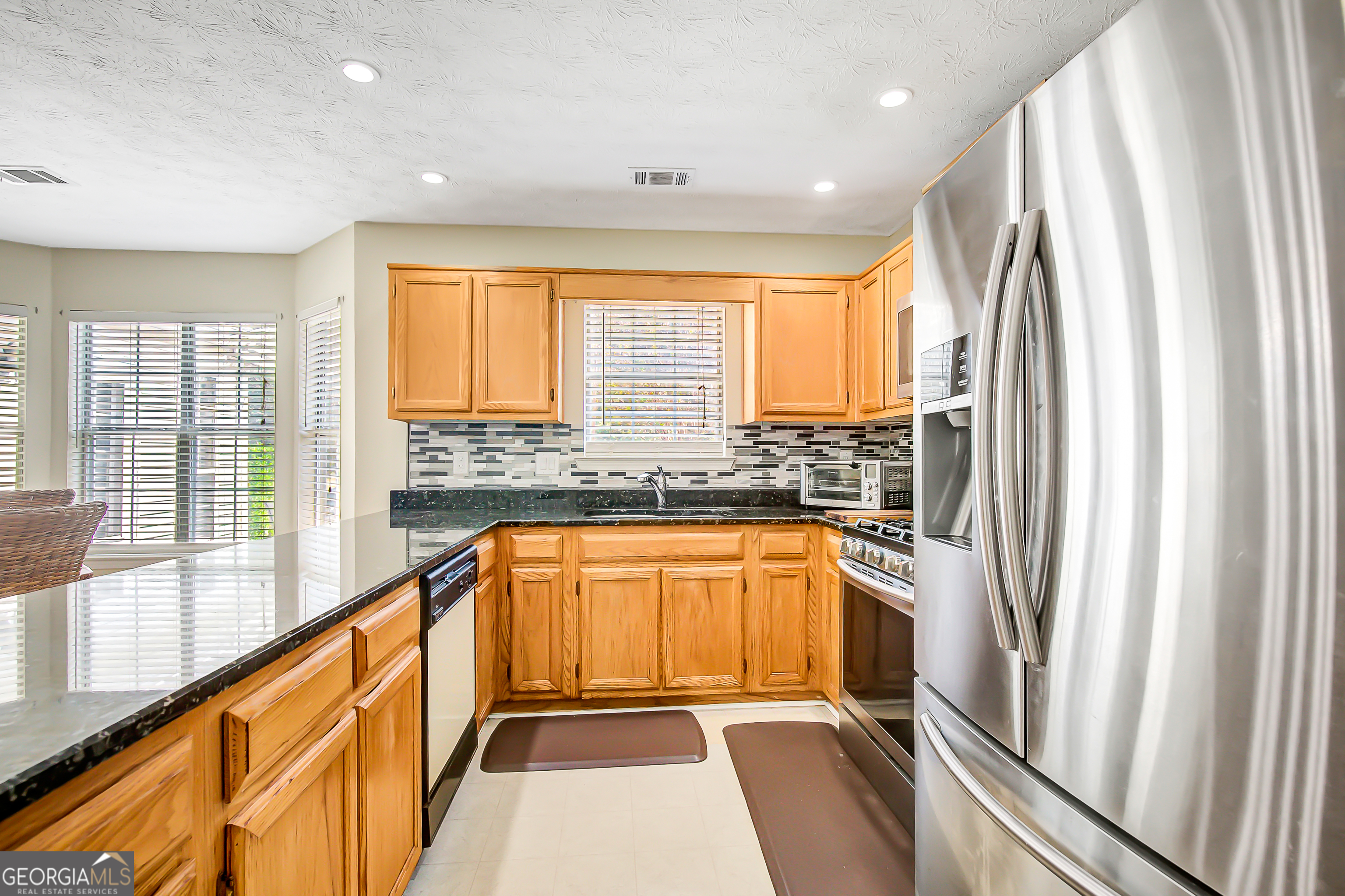 12350 Riviera Drive Fayetteville, GA 30215 - Photo 18 of 49 a view of a kitchen with a sink and refrigerator