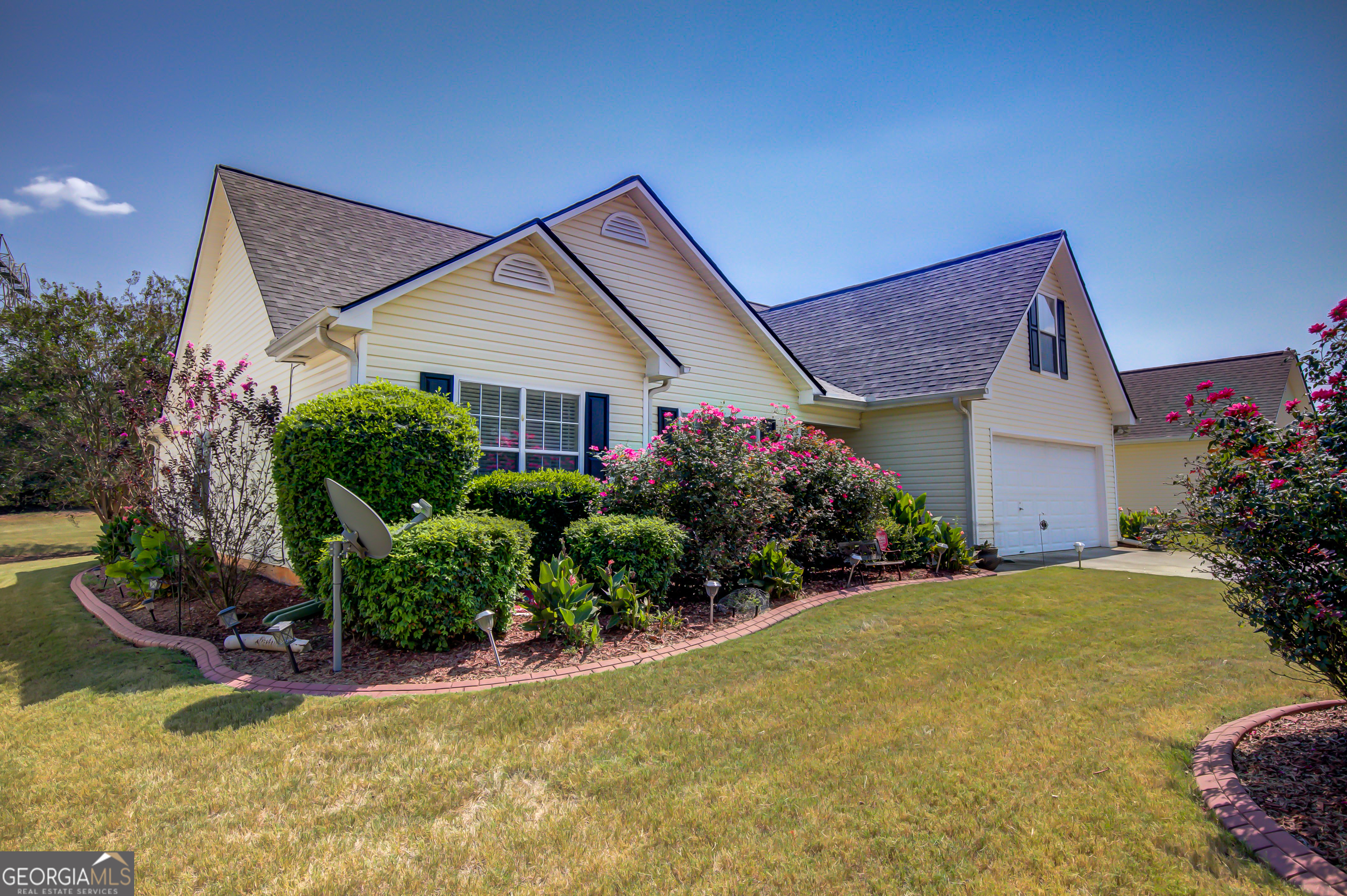 12350 Riviera Drive Fayetteville, GA 30215 - Photo 2 of 49 a front view of a house with garden