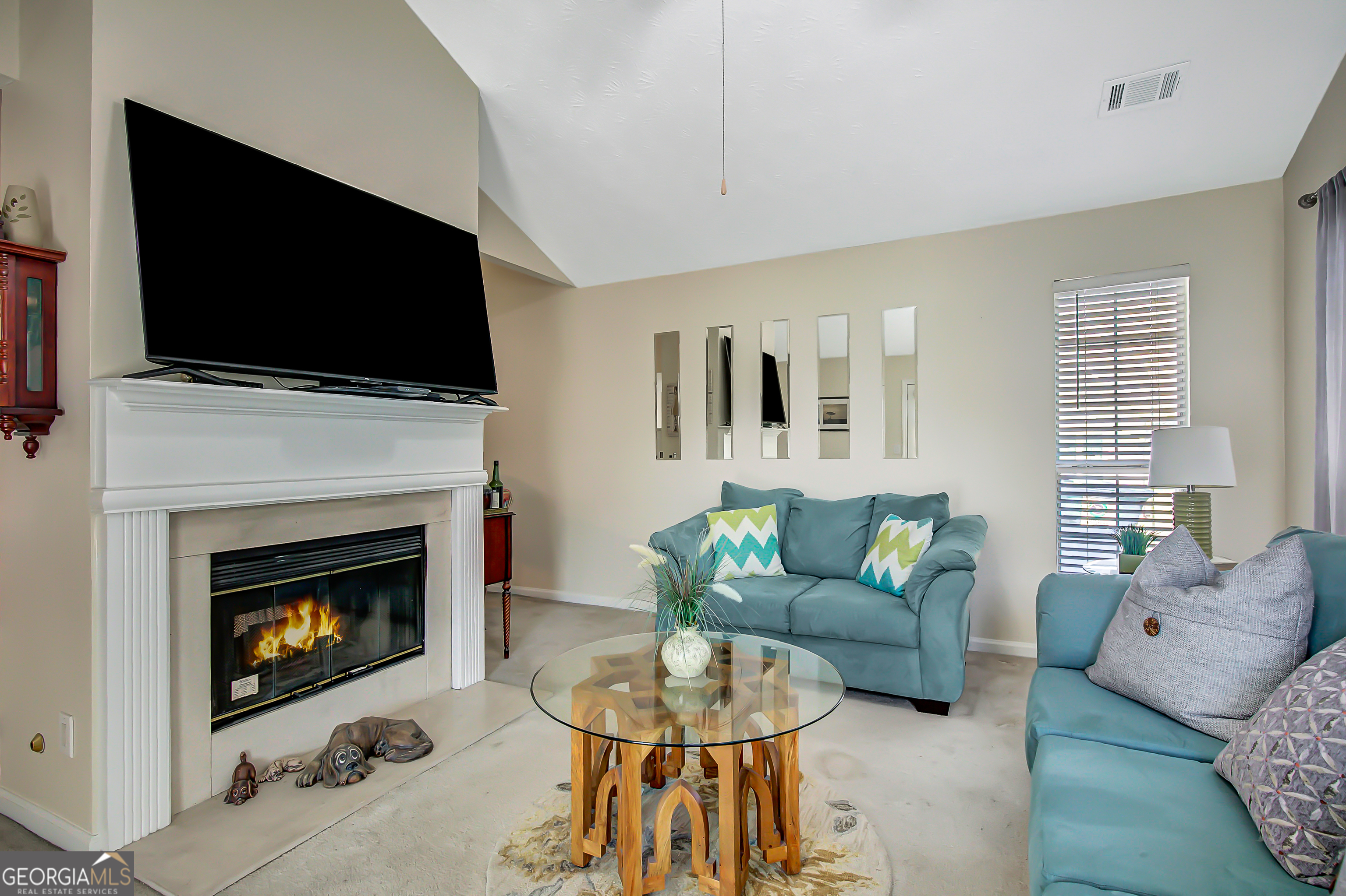 12350 Riviera Drive Fayetteville, GA 30215 - Photo 23 of 49 a living room with furniture a flat screen tv and a fireplace