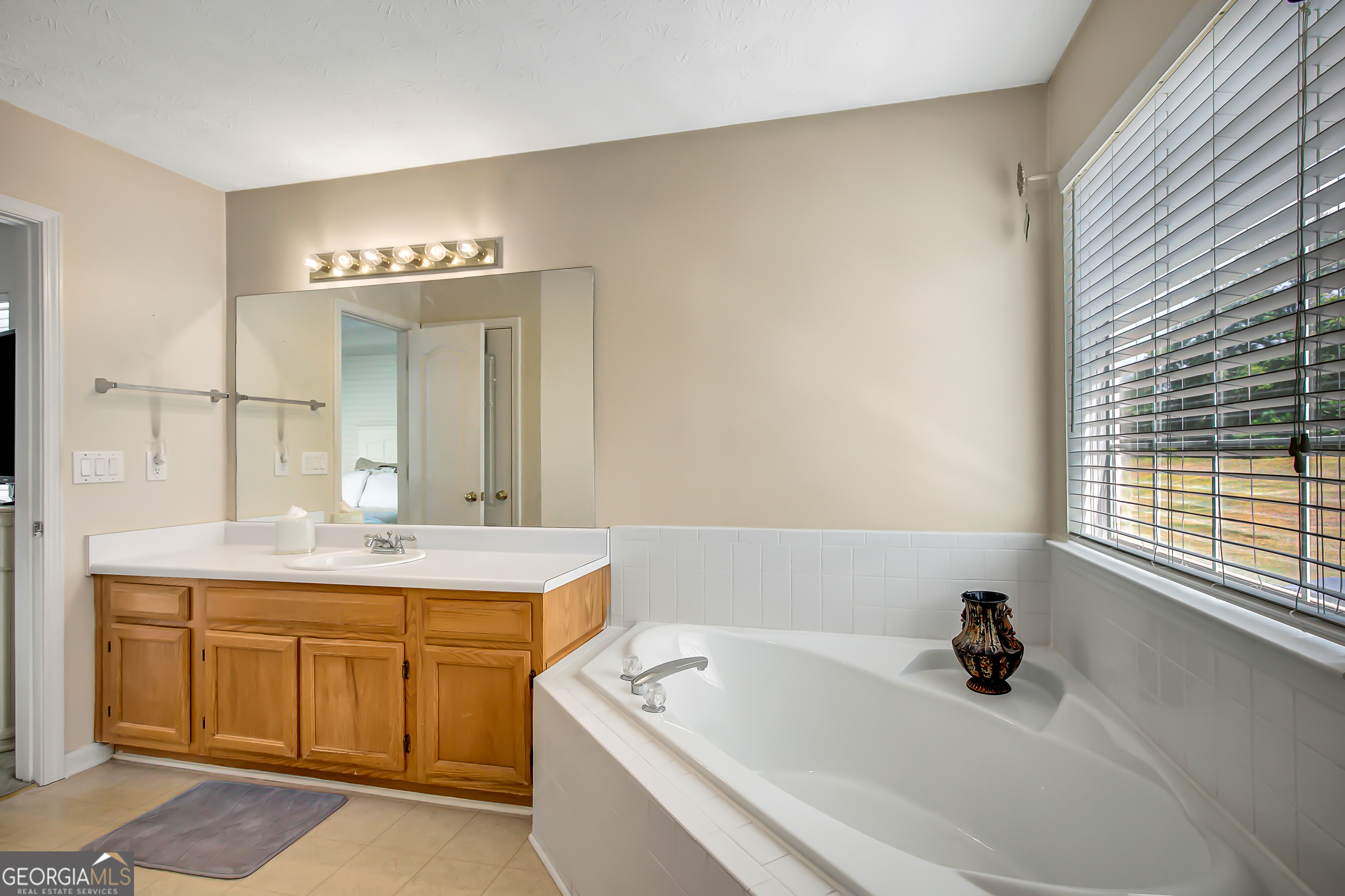 12350 Riviera Drive Fayetteville, GA 30215 - Photo 29 of 49 a bathroom with a tub sink and mirror