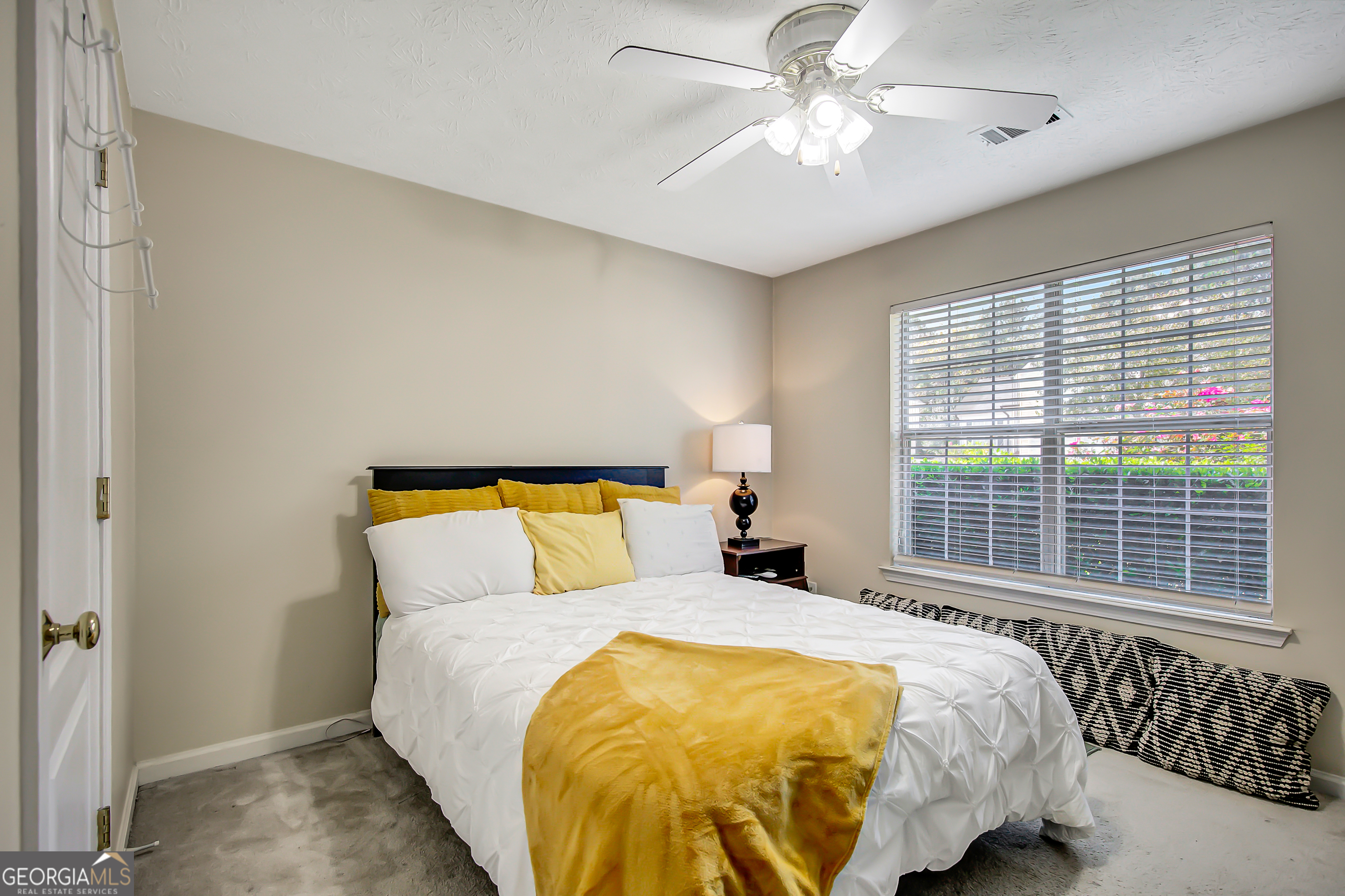 12350 Riviera Drive Fayetteville, GA 30215 - Photo 31 of 49 a bed sitting in a bedroom next to a window