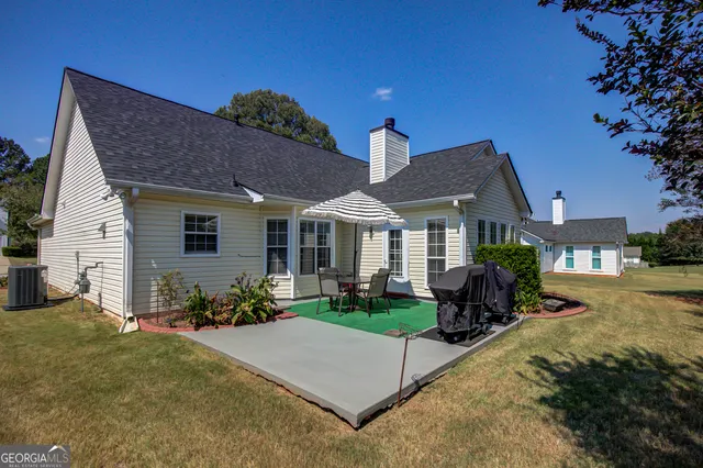 a front view of house with yard outdoor seating and green space