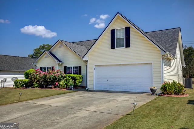 a front view of house with a garden