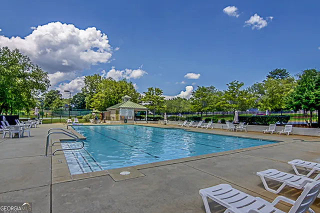 a view of swimming pool with outdoor seating
