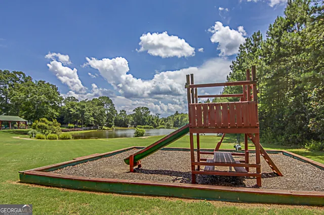 a view of a house with backyard and a slide