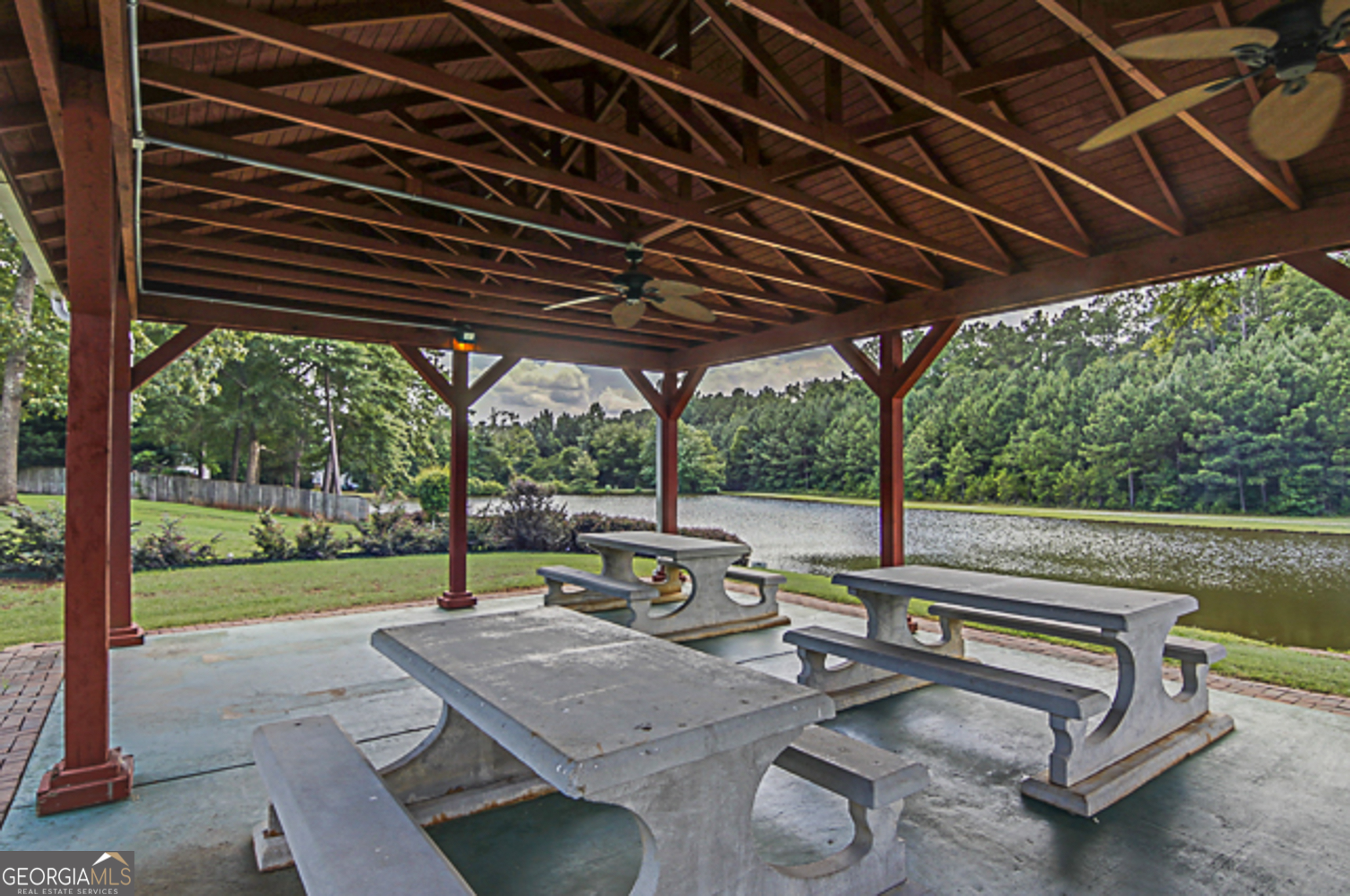 12350 Riviera Drive Fayetteville, GA 30215 - Photo 46 of 49 a view of a patio with table and chairs under an umbrella with a barbeque grill