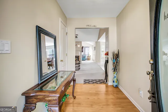 a view of a hallway with furniture and a mirror