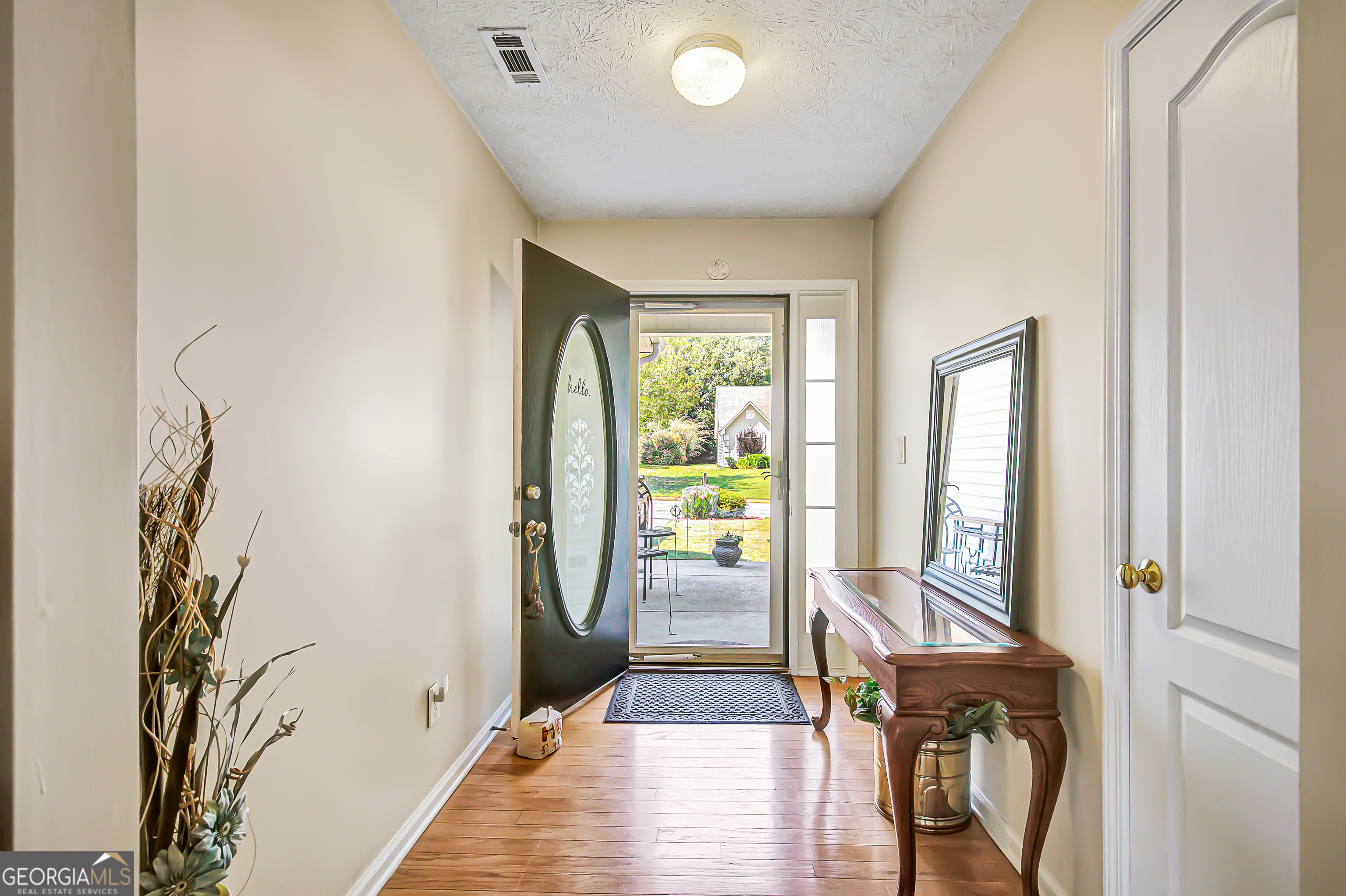12350 Riviera Drive Fayetteville, GA 30215 - Photo 7 of 49 a view of a hallway with wooden floor and glass door