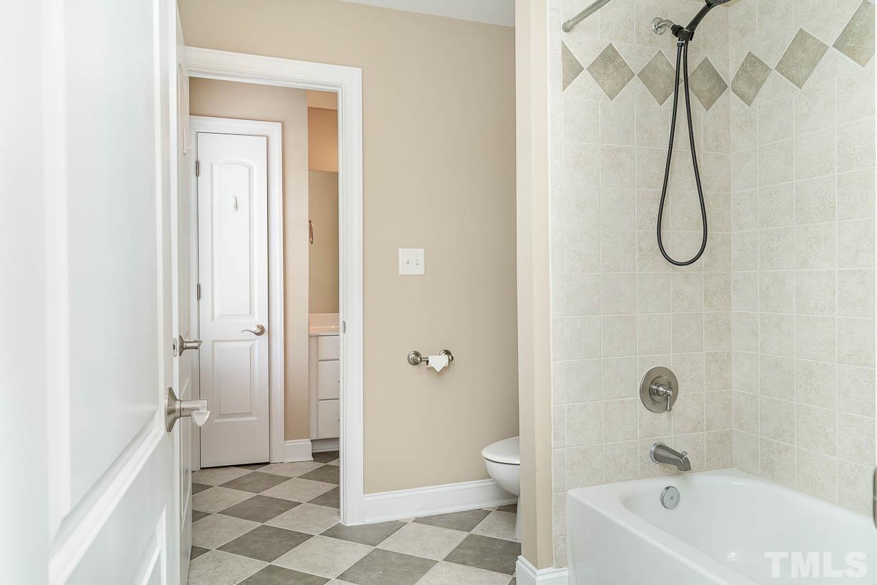 1317 Wynncrest Court Raleigh, NC 27603 - Photo 25 of 35 a bathroom with a bathtub a toilet and a shower