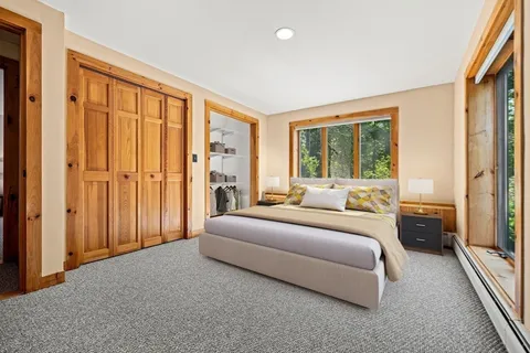 a bedroom with a bed and a large window