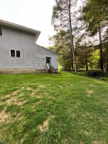 a backyard of a house with lots of green space