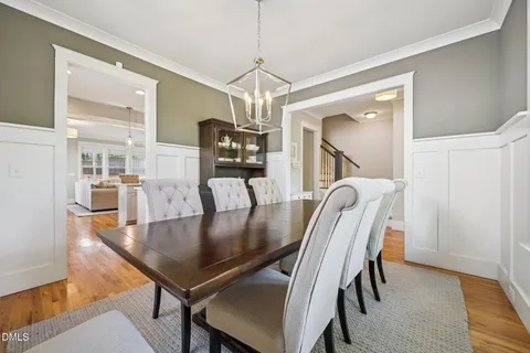 a kitchen with kitchen island a stove a table and chairs in it
