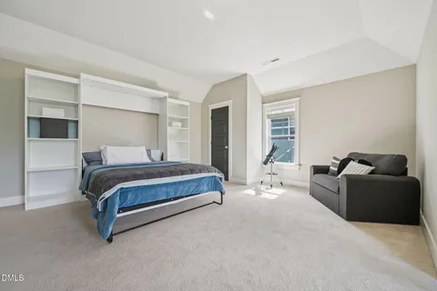 a living room with furniture and a book shelf