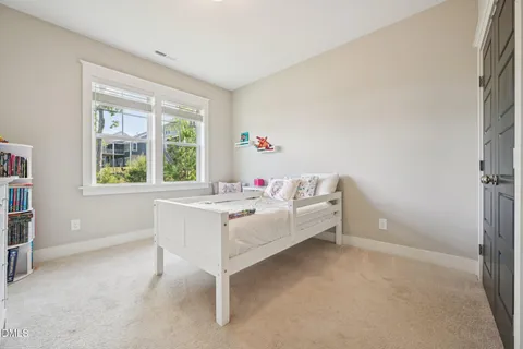 a bedroom with a bed and cabinets