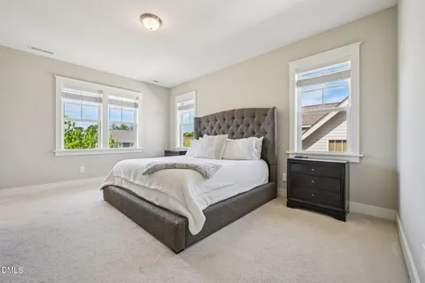 a spacious bedroom with a bed and a cabinets