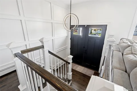 a view of staircase with railing and white walls