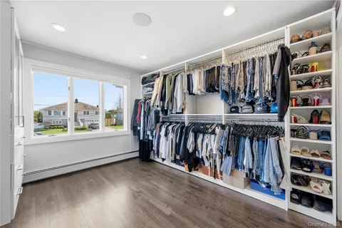 a view of walk in closet with clothes and shoes