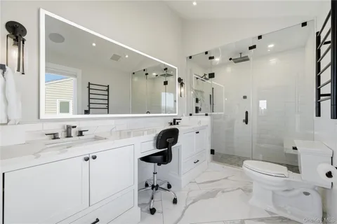 a bathroom with a sink toilet a mirror and shower