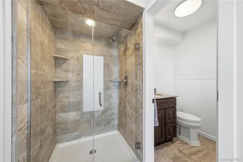 a bathroom with a shower and toilet