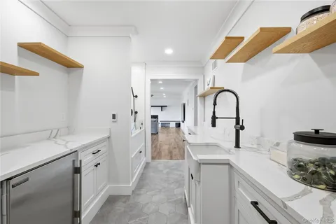 a view of a bathroom with a sink and mirror