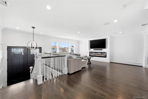 a view of a living room hardwood floor and a ceiling fan
