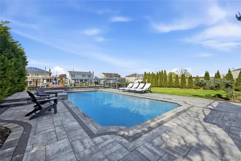 a view of a swimming pool with a lounge chair