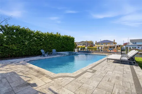 a view of swimming pool with chairs