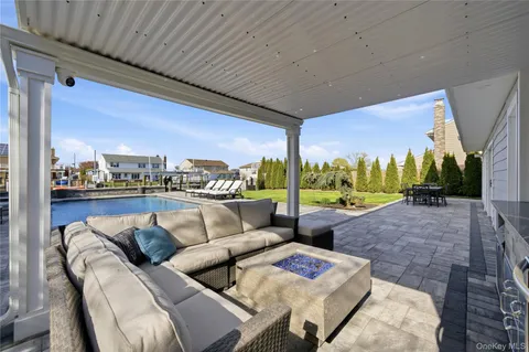 a balcony with furniture and a floor to ceiling window