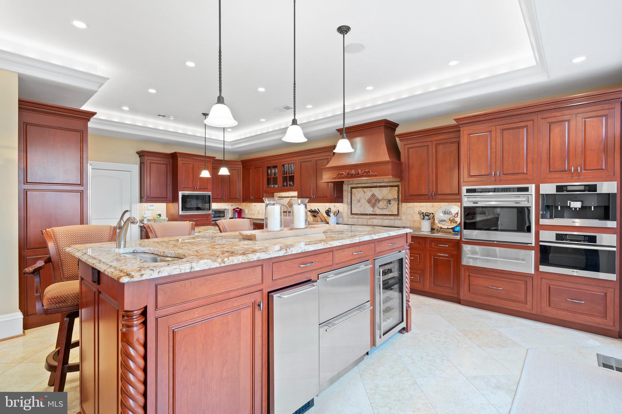 206 Harbor Drive Lusby, MD 20657 - Photo 24 of 109 a kitchen with stainless steel appliances granite countertop a sink a stove and a wooden floors