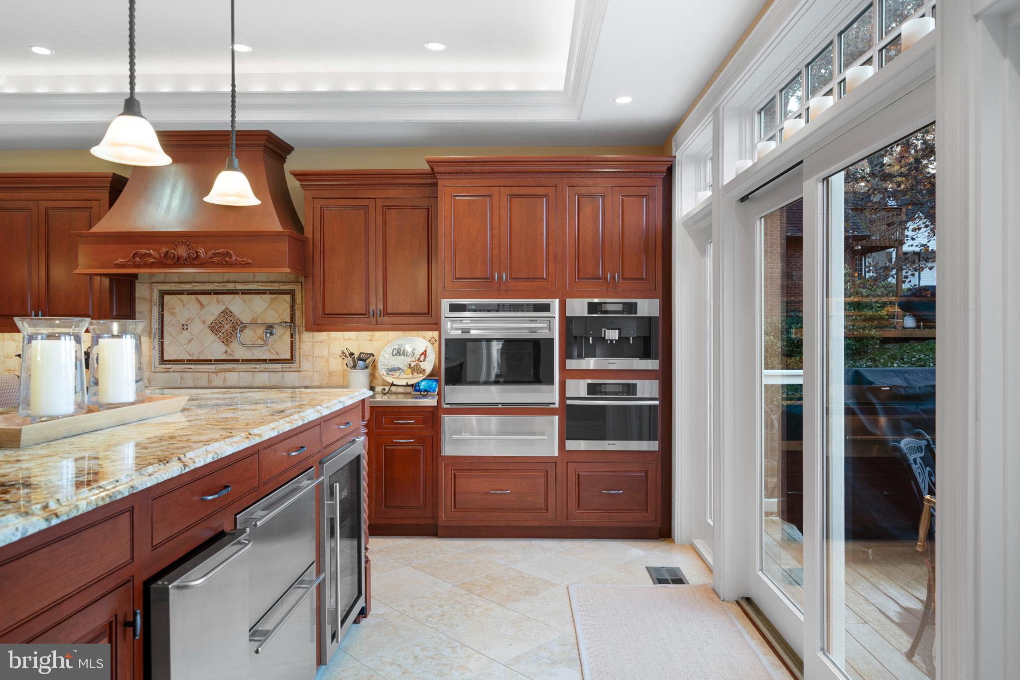 206 Harbor Drive Lusby, MD 20657 - Photo 25 of 109 a kitchen with stainless steel appliances granite countertop a refrigerator and a stove top oven