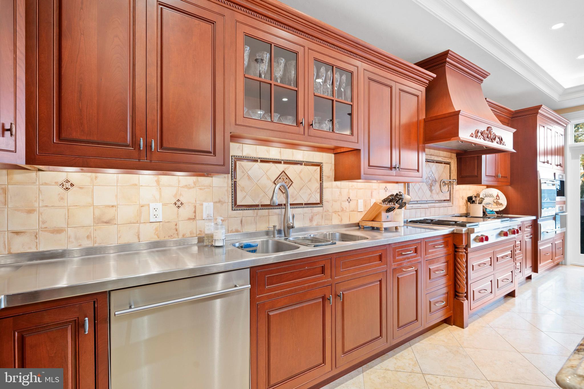 206 Harbor Drive Lusby, MD 20657 - Photo 32 of 109 a kitchen with stainless steel appliances granite countertop a sink stove and cabinets