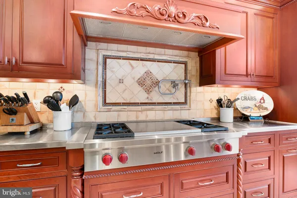 a bathroom with a tub a sink and a large mirror