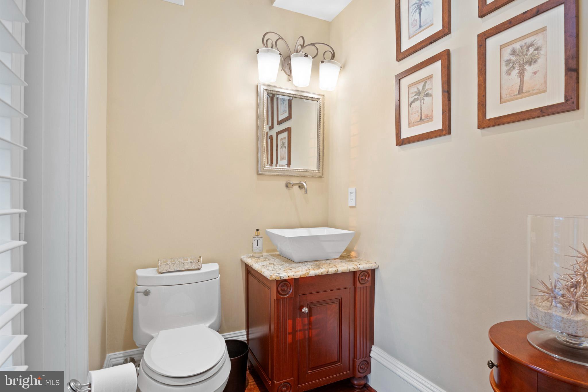 206 Harbor Drive Lusby, MD 20657 - Photo 35 of 109 a bathroom with a toilet a sink and mirror