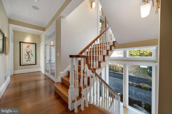 a living room with furniture a flat screen tv and a large window