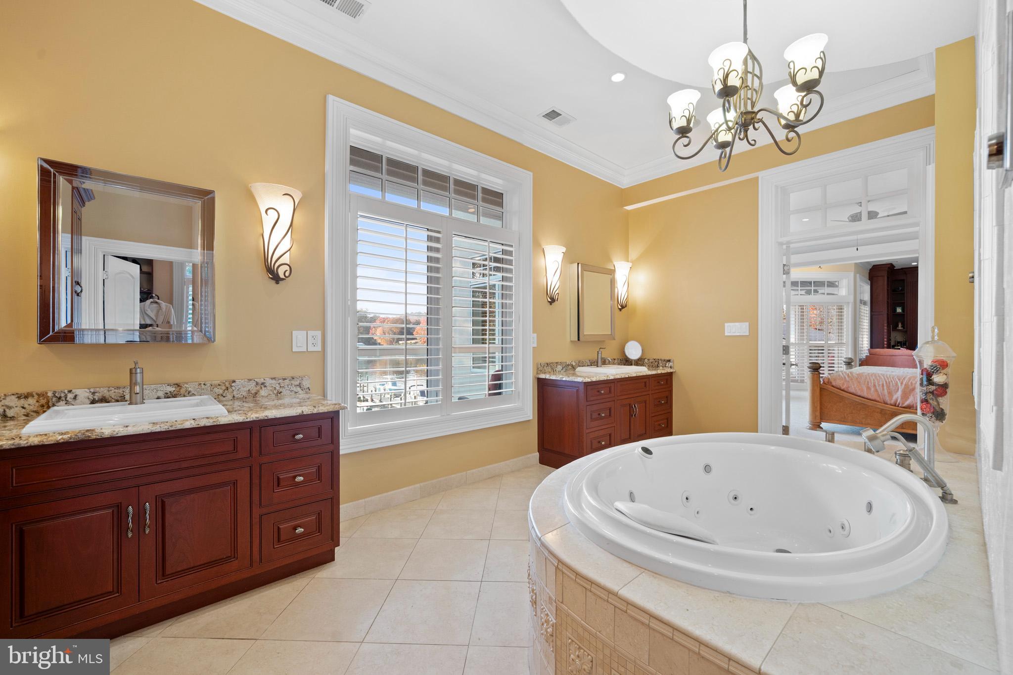 206 Harbor Drive Lusby, MD 20657 - Photo 46 of 109 a bathroom with a tub a double vanity sink a window and a mirror