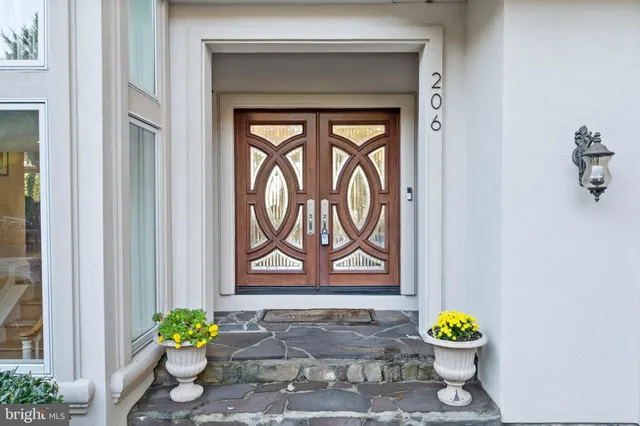 a view of a house with a yard and potted plants