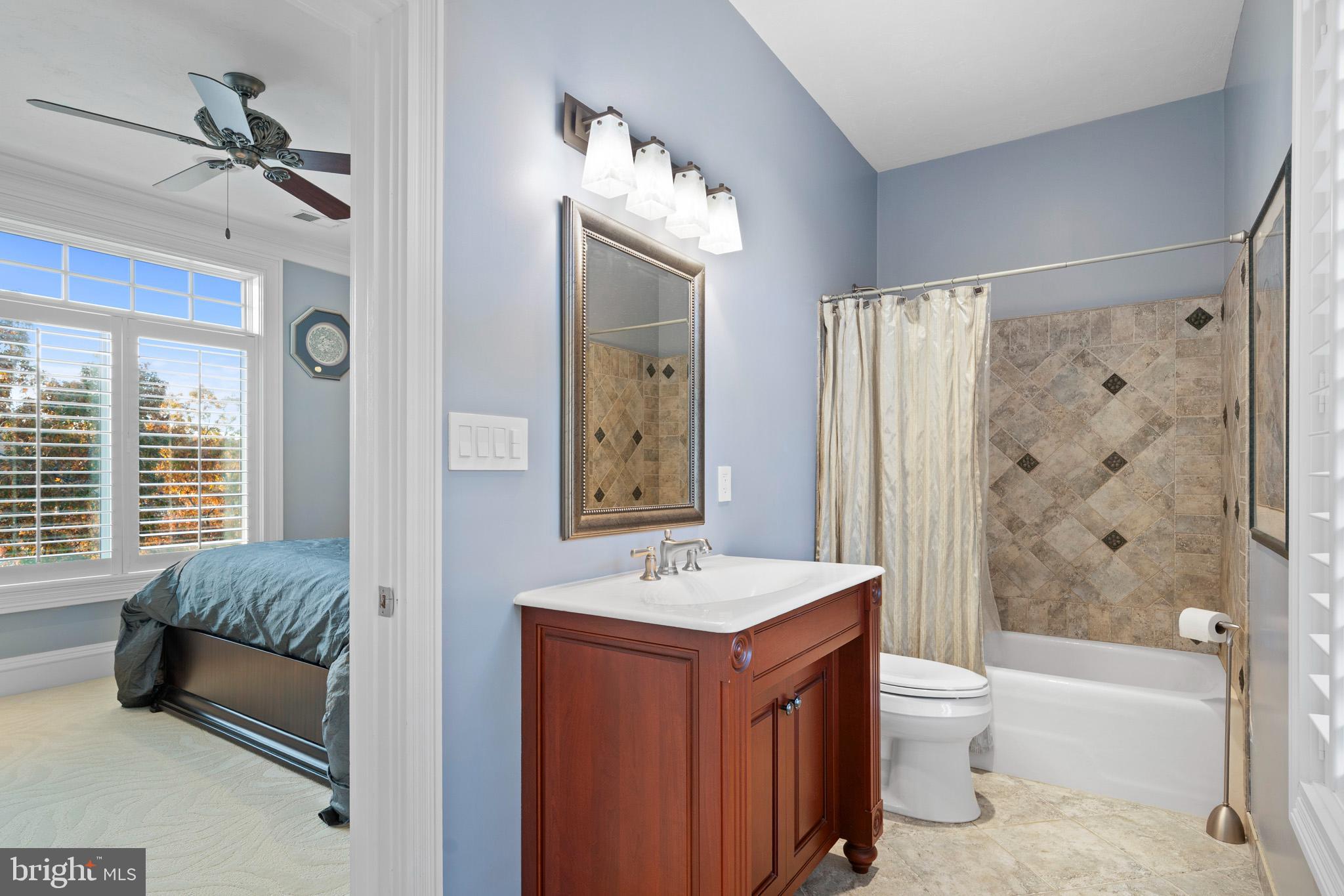 206 Harbor Drive Lusby, MD 20657 - Photo 63 of 109 a bathroom with a tub a sink and a large mirror