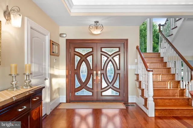 a view of a dining room with furniture one side kitchen view and wooden floor