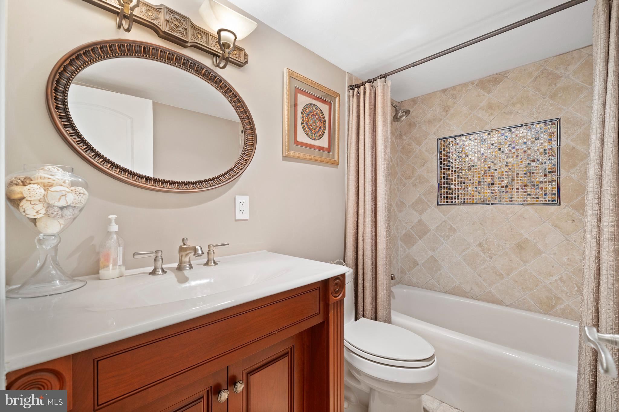 206 Harbor Drive Lusby, MD 20657 - Photo 77 of 109 a bathroom with a sink a toilet and a mirror