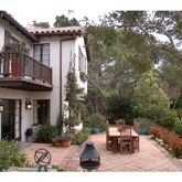 a view of a house with backyard porch and sitting area