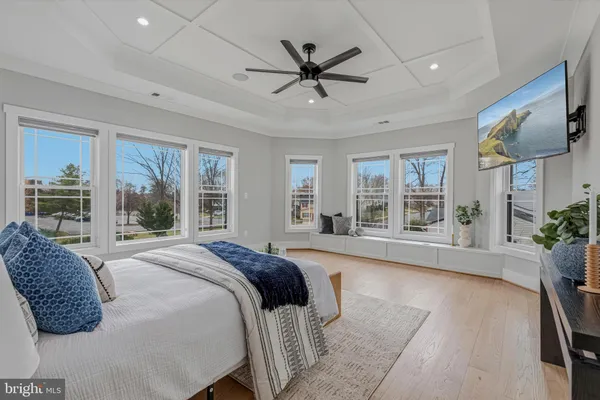 a view of empty room with wooden floor and windows