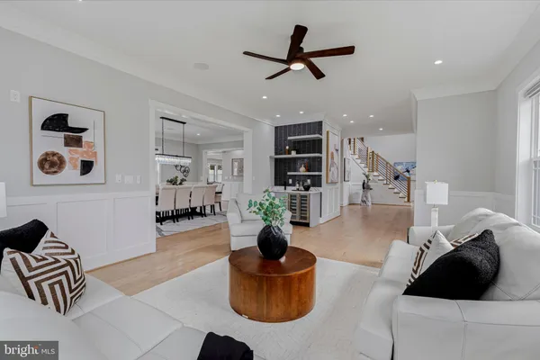 a dining room with furniture a chandelier and wooden floor