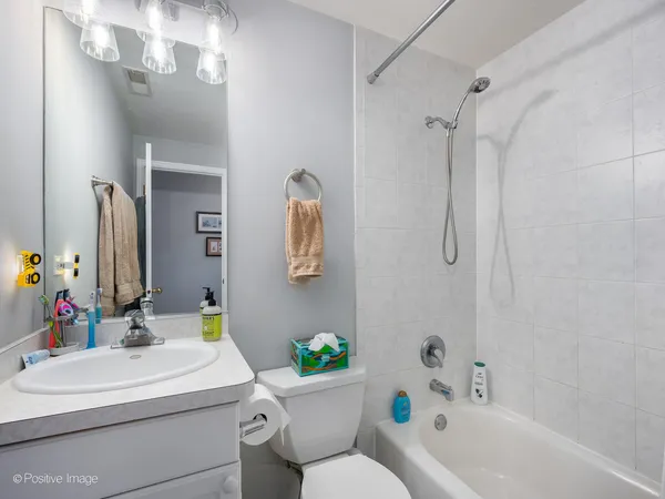 a bathroom with a sink mirror toilet and bathtub