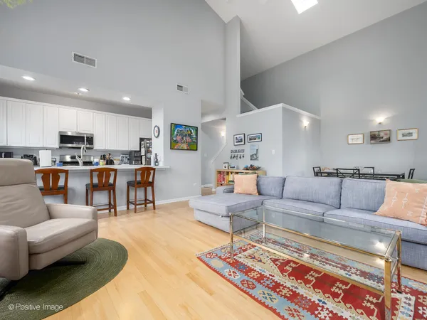 a living room with furniture and view of kitchen