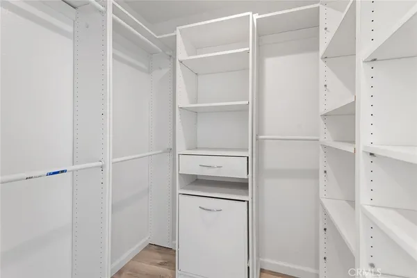 a view of walk in closet with empty racks