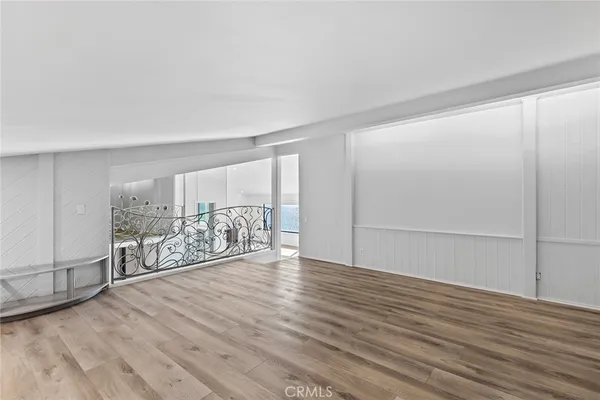 a view of a room with wooden floor