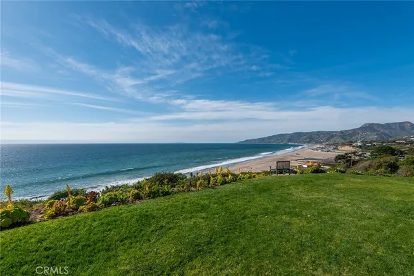 a view of an ocean with beach and outdoor space