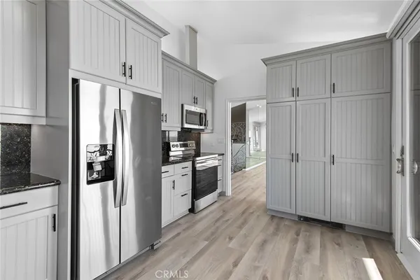 a kitchen with stainless steel appliances a refrigerator and cabinets
