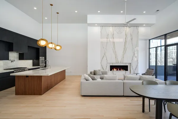 a living room with furniture a large window and a fireplace